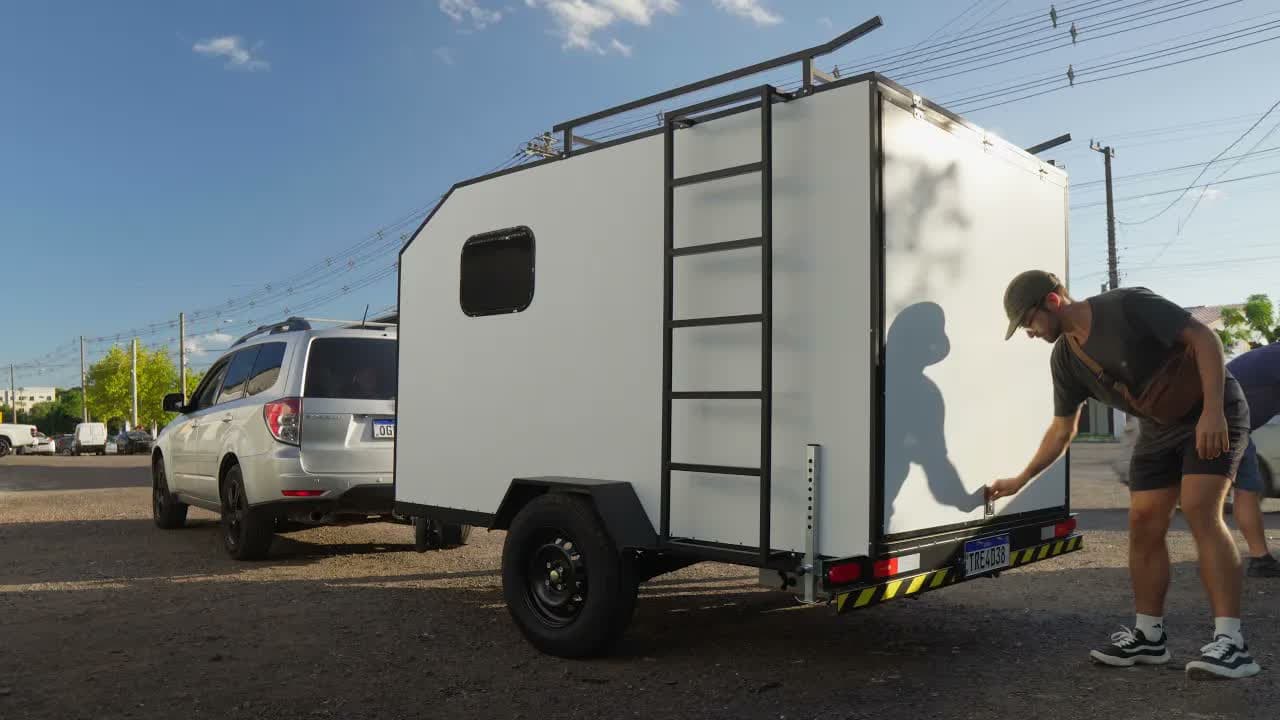 Nando next to the white mini trailer hitched to the Subaru Forester, cover of the post