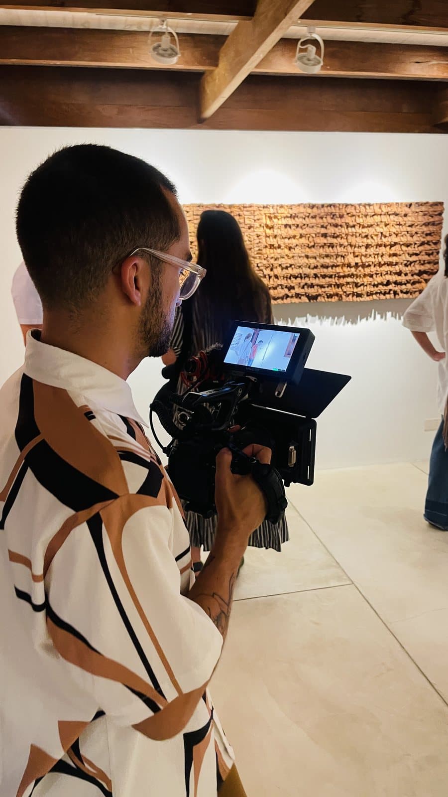 Nando filming the works in the exhibition room