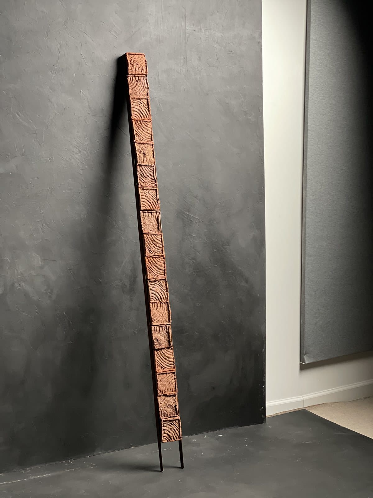 A brick work leaning against the studio wall