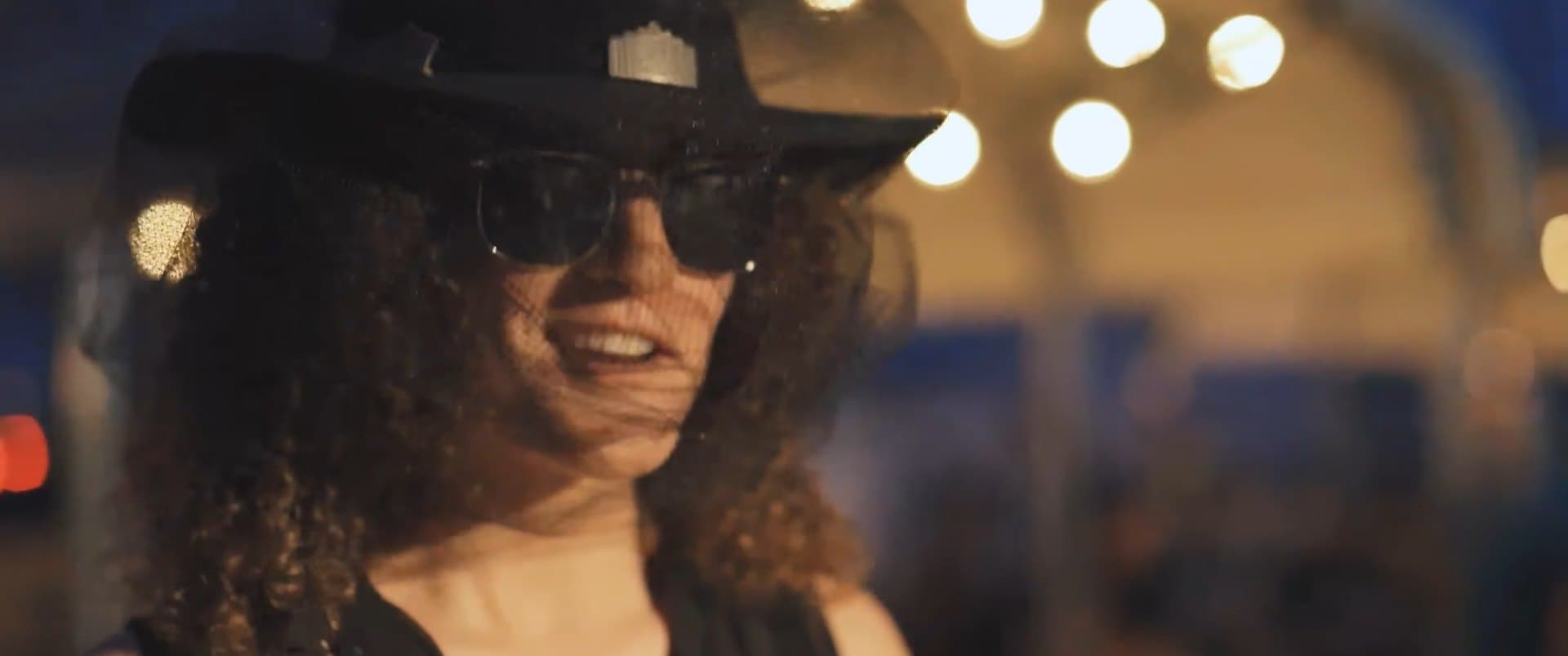 A woman in a hat and sunglasses