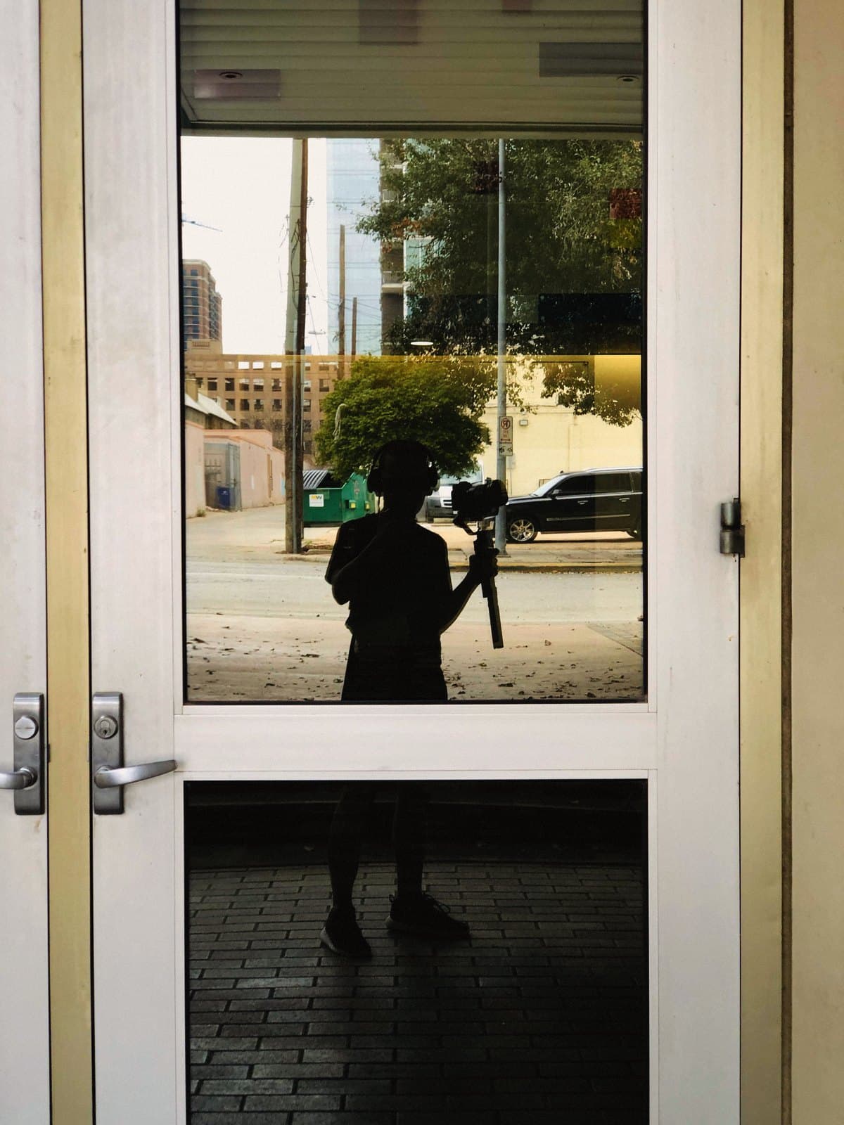 Reflection in a glass door, with the camera, in Austin
