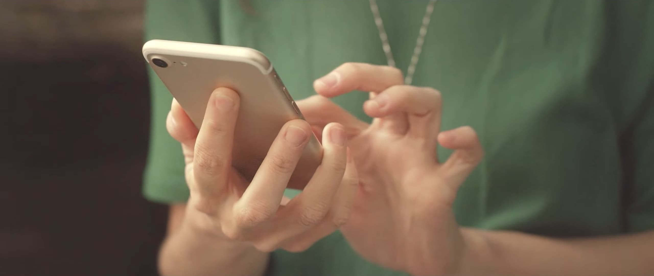 A woman’s hands typing on a phone
