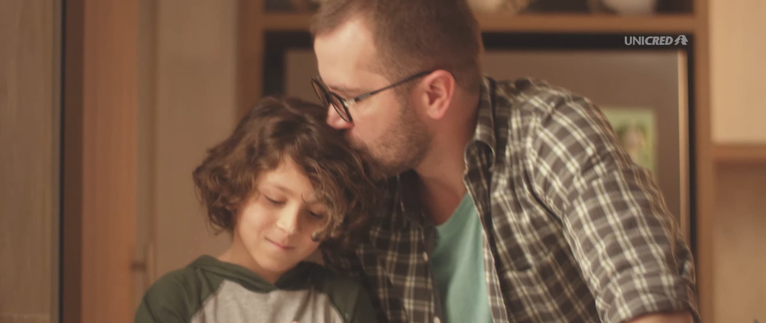 A father kisses his son’s head