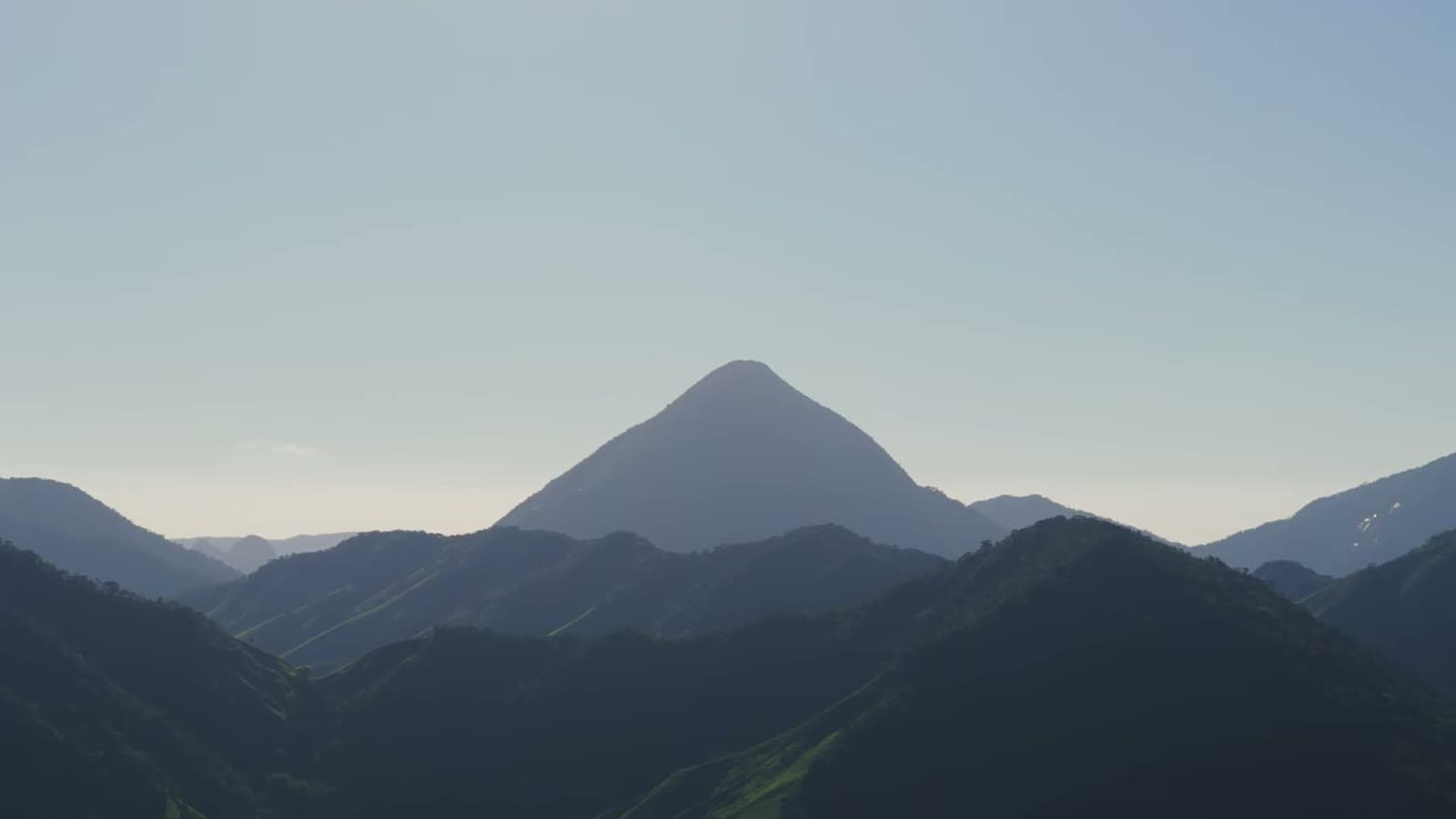 Pyramid-shaped mountain cut out against the clear morning sky